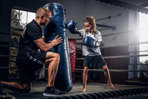 experienced-boxer-trainer-is-training-new-little-girl-boxer-special-competitions-using-punching-bag